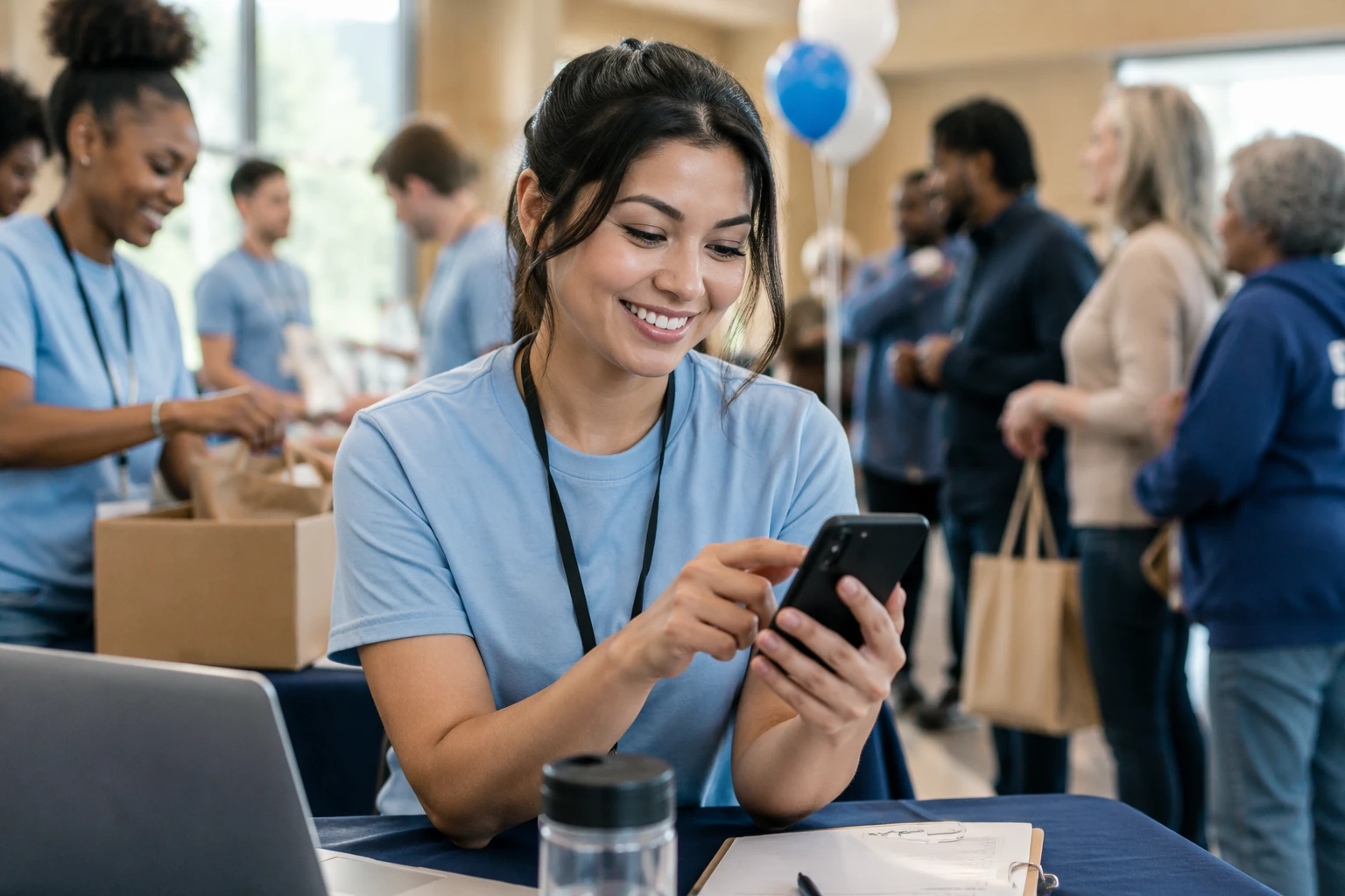 Community manager replying to donor comment on phone at charity event